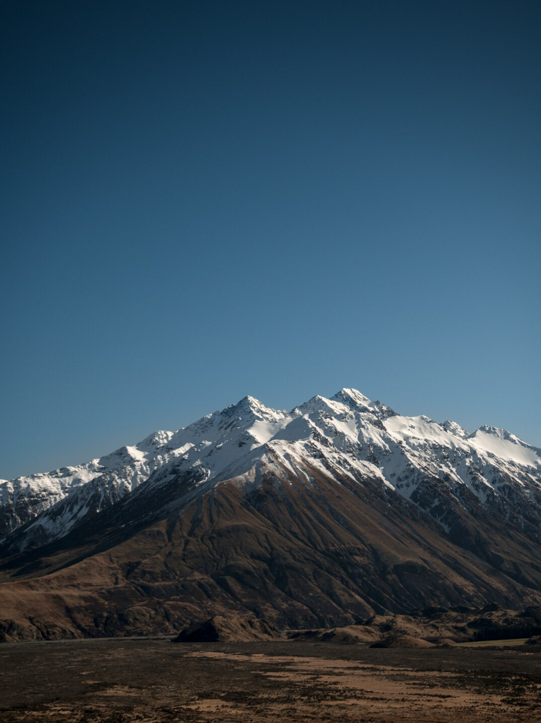 Snow-capped mountain range under a blue sky