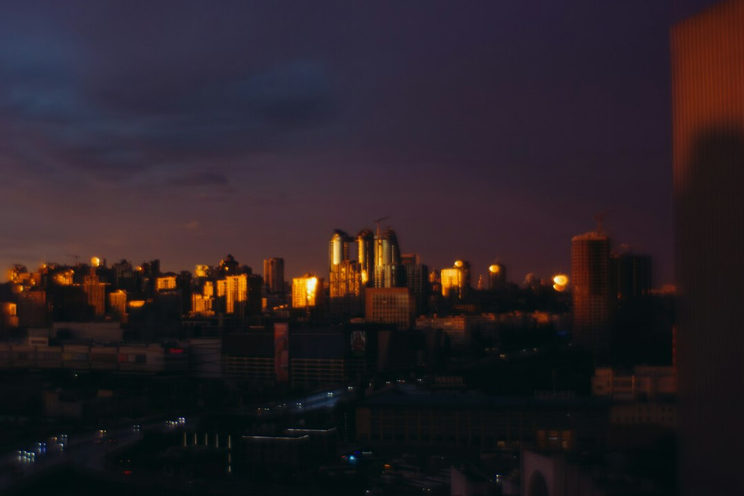 City skyline at dusk with warm lights